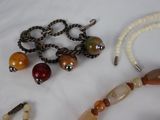 a necklace and bracelet with beads on a white surface
