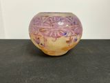 un vase violet et jaune posé sur une table