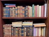 many old books on a book shelf in a library