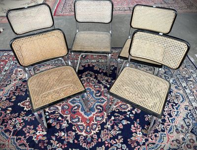 four chairs sitting in a circle on top of a rug