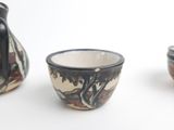 three different types of vases sitting on a white surface