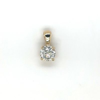 a close up of a diamond pendant on a white surface