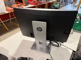 a computer monitor sitting on top of a white table