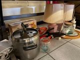 a kitchen counter with pots and pans on it