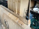 a cardboard box sitting on top of a pallet next to a pile of boxes