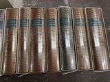 six books are lined up in a row on a table