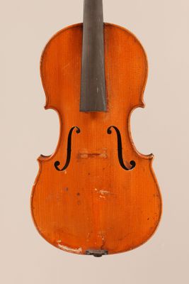 an old violin with a bow hanging from it ' s back