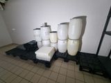 a stack of toilet bowls and a stack of toilet paper on a pallet