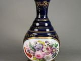 a blue vase with a floral design on it