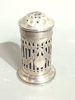 a silver salt shaker on a table with a white background