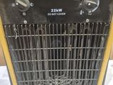 an electric heater sitting on top of a table next to a wall