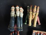 a lot of wooden toy figurines sitting on a table