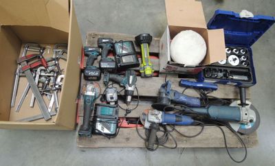 a box full of power tools and tools on the floor