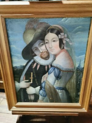 tableau représentant un homme et une femme tenant une canne devant un tableau