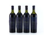three bottles of wine sit next to each other on a white surface