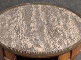 a table with a marble top and a wooden base