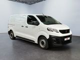 the white van is parked in the large room of the building
