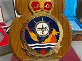 a wooden plaque with a picture of a ship on it