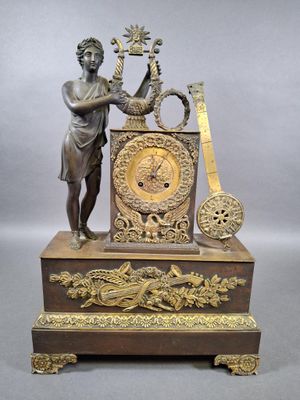 a bronze statue of a man playing a musical instrument