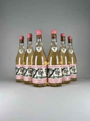four bottles of gin are lined up in a row on a table