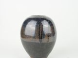 an image of a black and brown vase on a white background