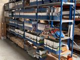 a large rack with many items on it in a warehouse
