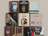 several books on a table with a horse head on top of them