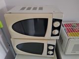 two microwaves that are stacked on top of each other
