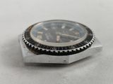 a watch that is sitting on top of a piece of metal