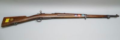 an old rifle with a wooden barrel and a wooden handle