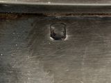 close up of a metal pan with a hole in it