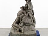 statue of jesus on a cart with a woman on it