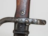 a close up of a metal object with a wooden handle
