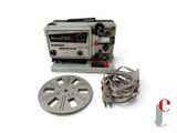 an old movie projector sitting next to a reel and a cable
