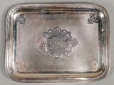 an antique silver plate with a picture of a man and woman on it