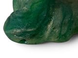 a close up of a piece of green glass on a white surface