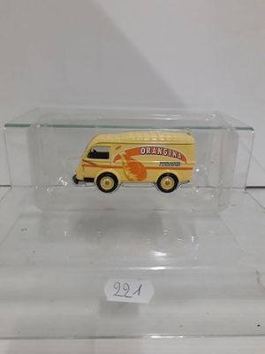a small toy bus in a clear box on a table