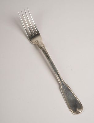 a fork that is sitting on a white table