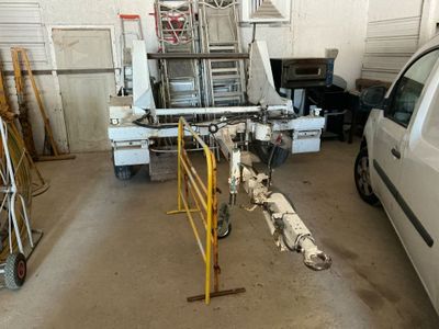 vehicles are parked in a garage with a truck in the background