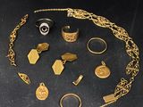 gold jewelry on a black surface