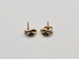 a pair of gold earrings with sapphire stones