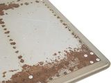 a metal table with a rusted surface on top of it