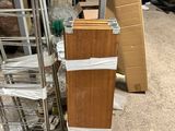 a stack of boxes sitting on the ground next to a ladder