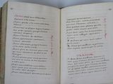 an open book with writing on it sitting on a table