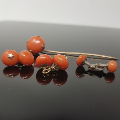 some orange beads are sitting on top of a black surface