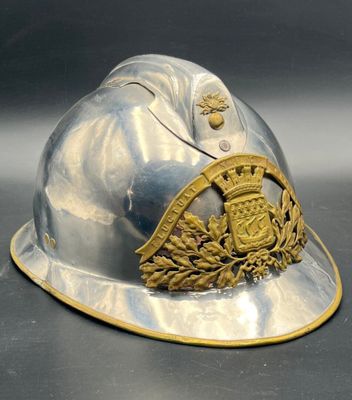 a silver helmet with a gold emblem on it