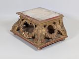 a small table with a marble top sitting on a white surface