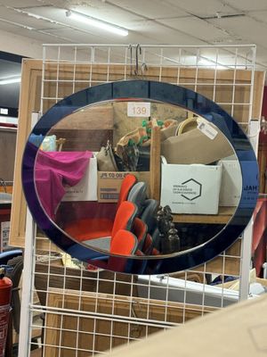 a mirror that is hanging on the wall in a store