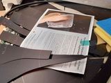 a pile of papers on top of a computer desk