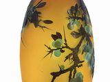 a yellow vase with blue flowers on it on a white background